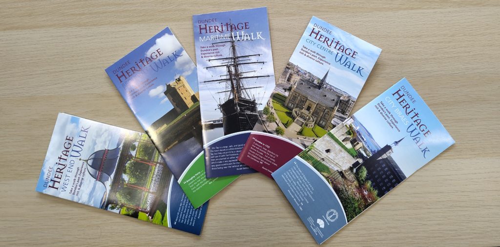 5 heritage walk leaflets arranged in a fan shape.