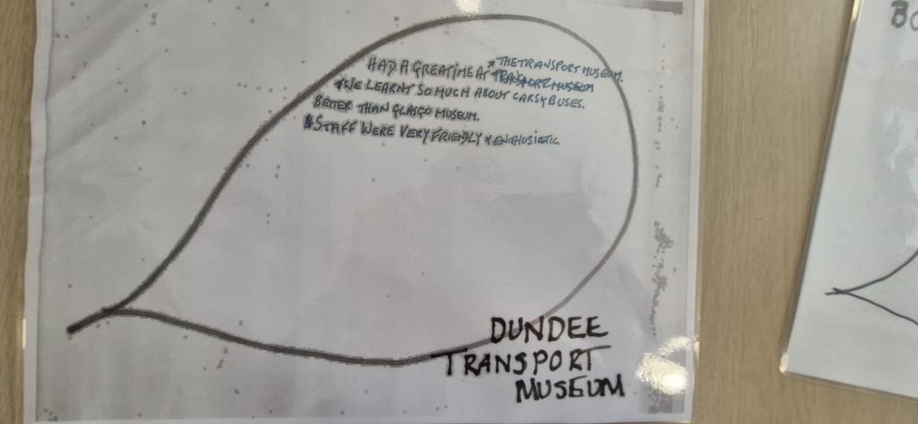 Text inside a speech bubble reads Had a great time at the Transport Museum. We learnt so much about cars & busses. Better than Glasgow museum. Staff were very friendly and enthusiastic.